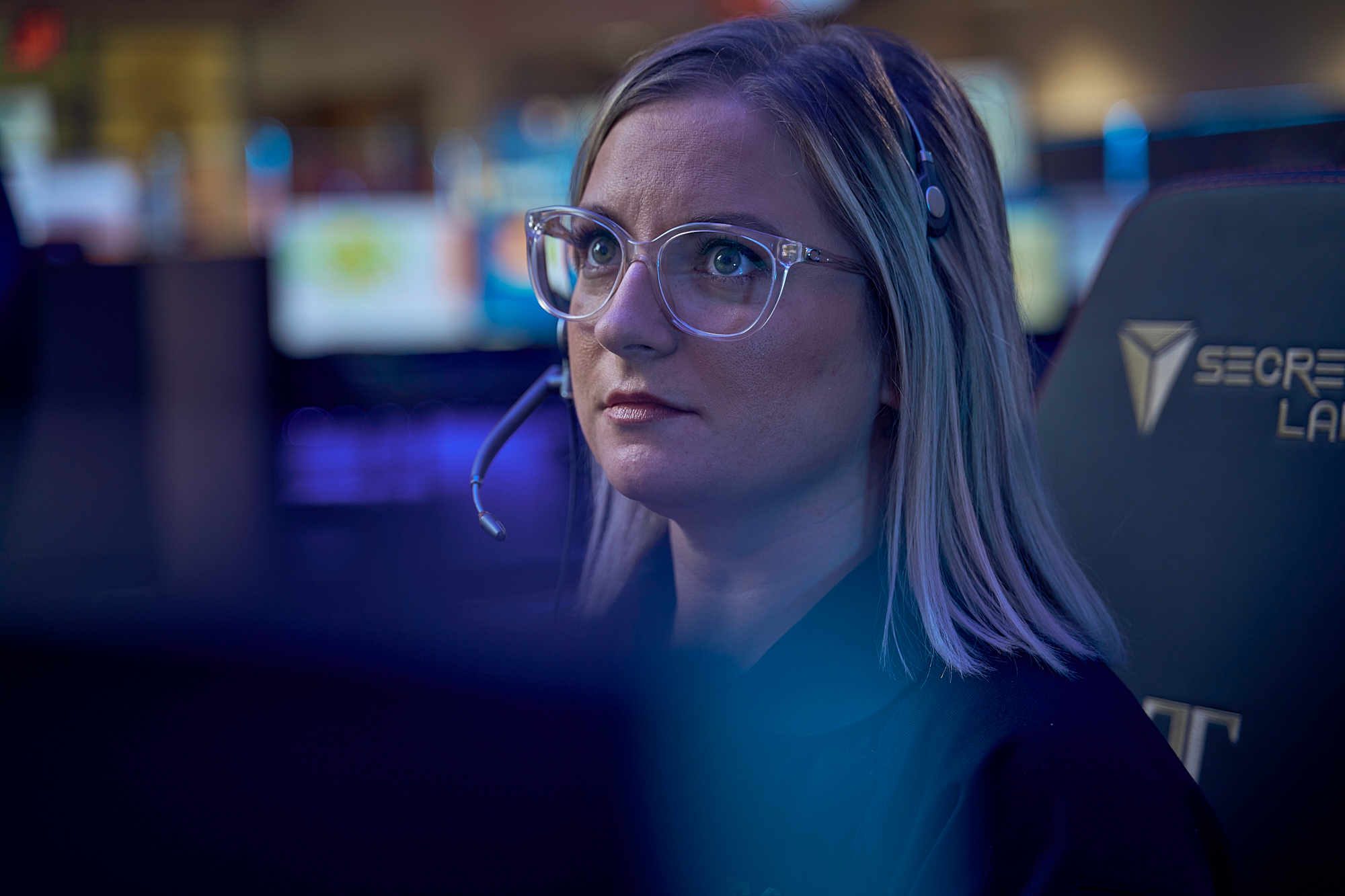a Focused Woman with Long Blonde Hair and Glasses Coordinates Emsa Response at a Control Center, Blue-lit Screens Behind Her. – Amatucci Photography - Amatucci Photography A focused woman with long blonde hair and glasses coordinates emsa response at a control center blue lit screens behind her amatucci photography