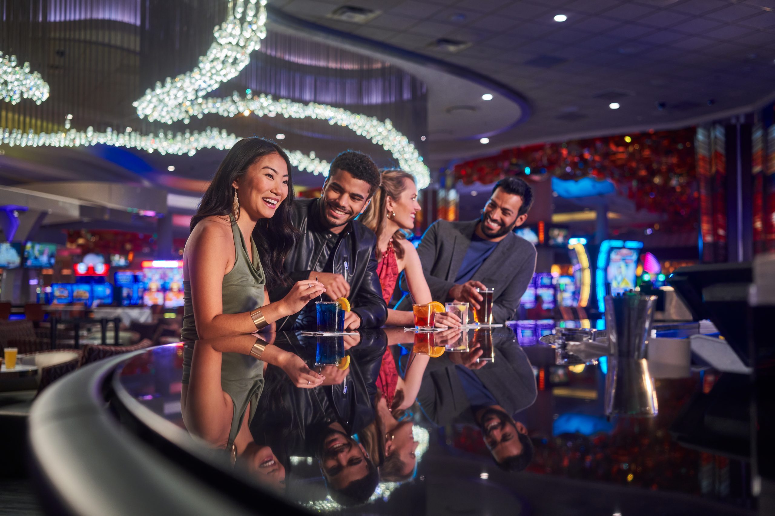 Four Friends Laugh Together with Drinks at Mystic Lake Casino Bar, Minnesota, Surrounded by Slot Machines and Festive Lights. – Amatucci Photography - Amatucci Photography Four friends laugh together with drinks at mystic lake casino bar minnesota surrounded by slot machines and festive lights amatucci photography