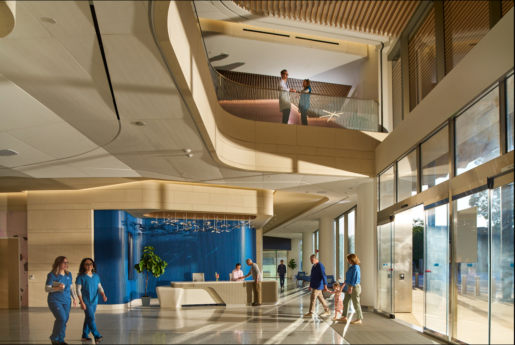 in City of Hope Plaza's Airy New Lobby, Staff Mingle As a Family Enters; Two People Observe from the Balcony at a Healthcare Event. – Amatucci Photography - Amatucci Photography In city of hope plazas airy new lobby staff mingle as a family enters two people observe from the balcony at a healthcare event amatucci photography