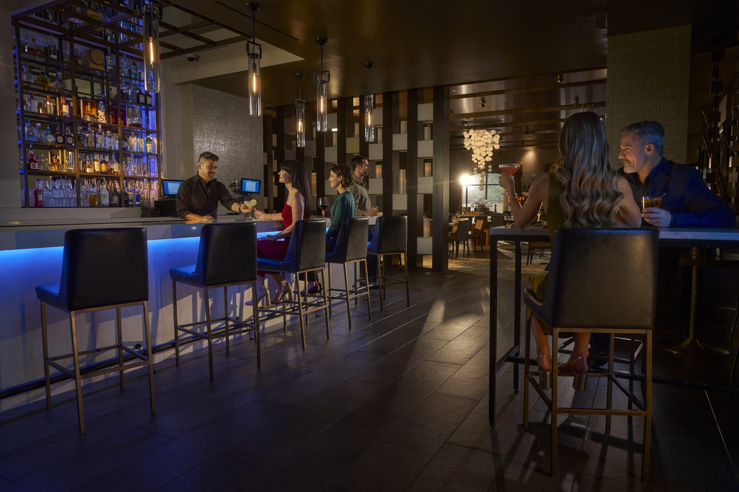 at Chumash Casino Resort, a Moody Bar Glows Blue As Guests Chat and Unwind—ideal for Casino Nightlife and Social Events. – Amatucci Photography - Amatucci Photography At chumash casino resort a moody bar glows blue as guests chat and unwindideal for casino nightlife and social events amatucci photography